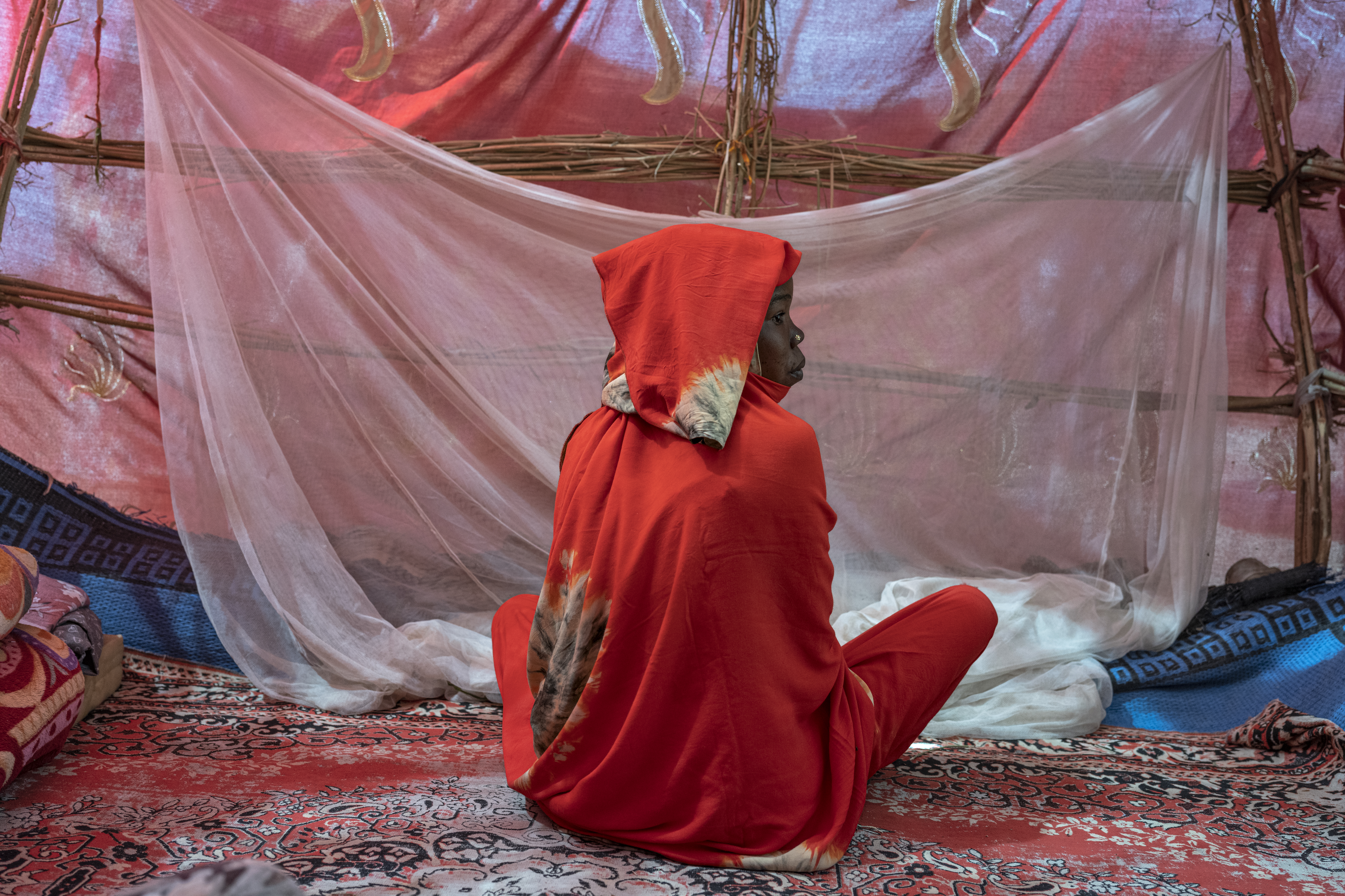 child in front of mosquito net